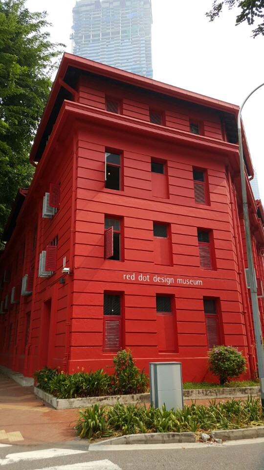 Red brick building with green trees surrounding it