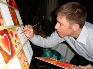 A man paints a painting.