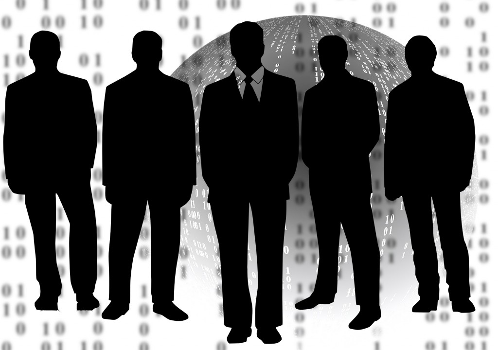 Silhouetted professionals stand around in front of a virtual background