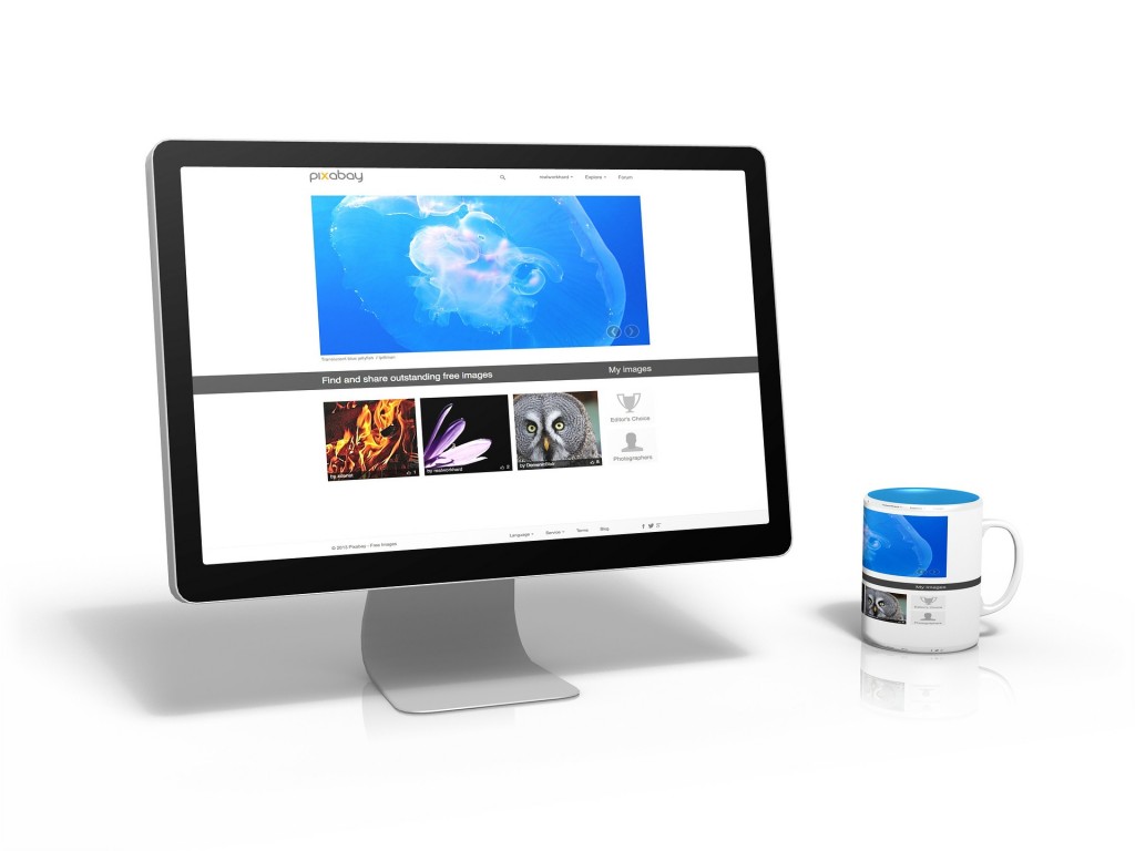 A computer open to a website with a blue window and three smaller ones. On the left is a mug. 